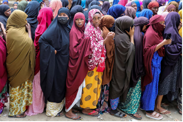 Women queue to have their biometrics recorded during the voter registration for election
