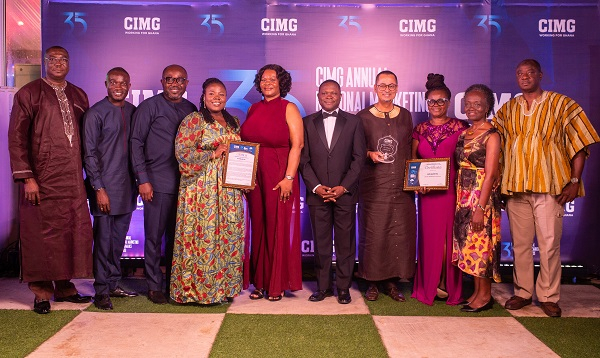 Some managers and staff of GCB Bank displaying their citations and shield