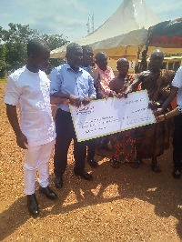 CEO of the company and his colleagues presenting the cheque