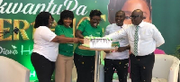 Diana Hamilton (middle) and other dignitaries cutting the cake at the launch