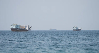 Vessels sail near the Strait of Hormuz, as seen from Musandam, Oman
