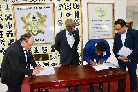 Officials signing the MoU