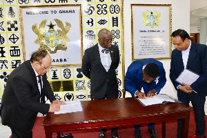 Officials signing the MoU