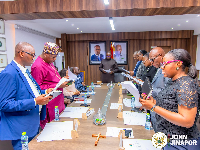 A photo of John Jinapor (middle) and members of the Energy Commission board