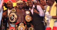 Gyan and his entourage pose for the cameras with their boxer Tagoe