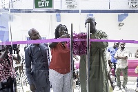Amanda assisting Mr Thomson cut the ribbon for the official opening while Pastor Adjatey looks on