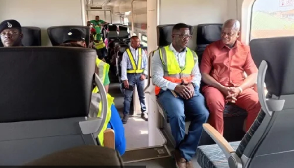 Bukari Nikpe (far right) in a conversation with Dr Appoh onboard the train