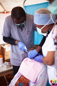 A dentist attending to a patient