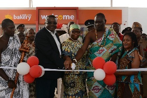 Mr Ebenezer Faulkner being assisted by the Chief of Adabraka and other dignitaries