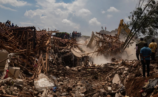 Excavator helps search for people trapped under debris after a landfill collapsed in Kampala