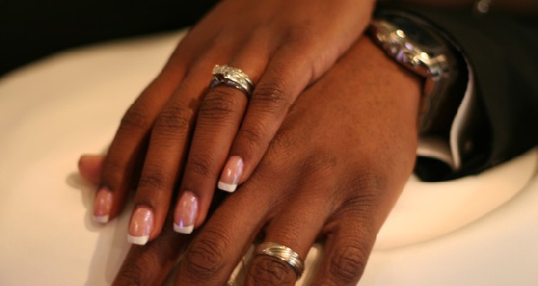 Couple flaunt wedding ring.