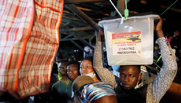 A Polling Agent carrying the ballot box
