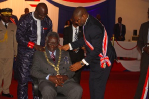 President George Manneh Weah decorating John Agyekum Kufuor