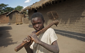 A  young boy holding an axe