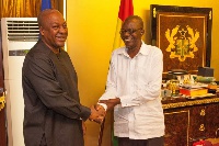 Kenneth Wujangi (right) in a handshake with President John Mahama