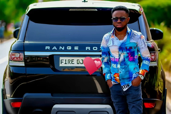 Prophet Fire Oja standing beside his Range Rover