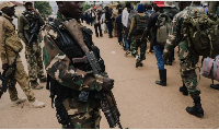 M23 rebels guard a unit of surrendering Congolese soldiers in Bukavu