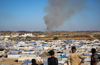 Children overlook smoke near Gaza's Nuseirat camp
