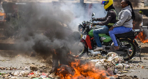 Nearby roads were blocked by piles of burning rubbish and littered with rocks