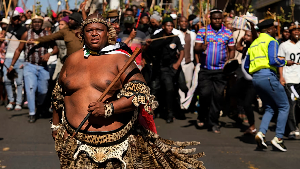 A protester dressed traditional attire march against illegal immigration, in Johannesburg, June 26