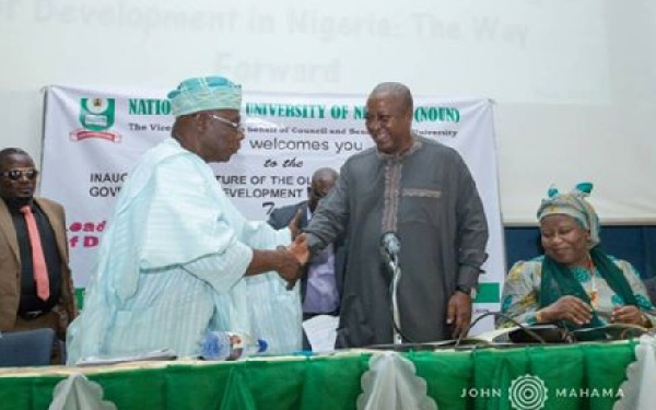 Former President John Dramani Mahama in a hand shake with Former President Obasanjo