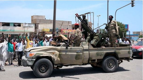 Sudanese greet army soldiers, loyal to army chief Abdel Fattah al-Burhan, in the Red Sea City
