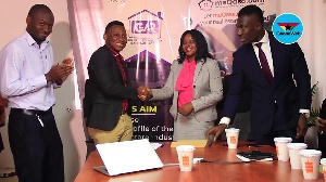 CEO of Meqasa Kelvin Nyame and co-founder of GAR Hannah Atiase shake hands after signing the deal