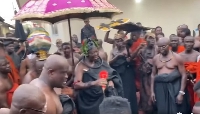 Otumfuo Osei Tutu II (with umbrella over his head) dancing