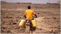 A man ferries water to his home in Kenya’s drought-hit Marsabit County