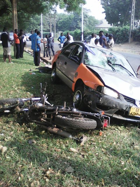 Taxi and motorbike lying on the ground as Police investigates incident