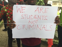 A KNUST student holding a placard
