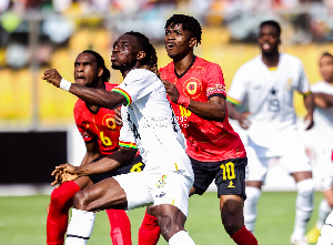 Gideon Mensah (in white) in action against Angola