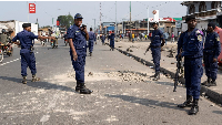 Police officers secure a road cleared off barricades erected in Goma, North Kivu province