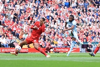 Antoine Semenyo strikes the ball through the legs of Van Dijk