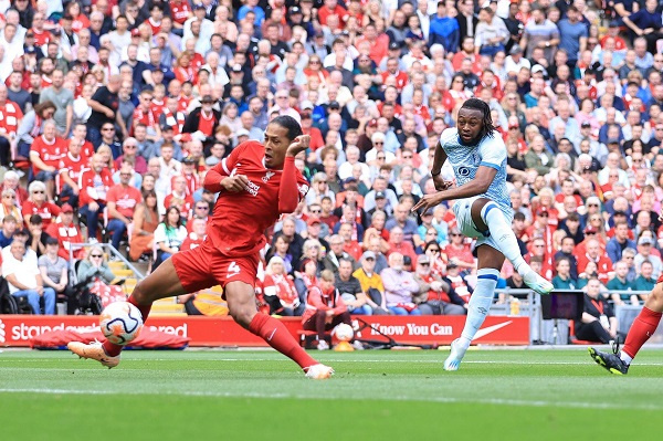 Antoine Semenyo strikes the ball through the legs of Van Dijk