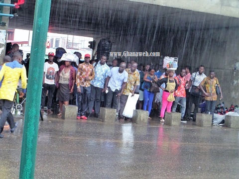 Some people in the tunnel waiting for the rain to stop