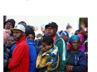 People gather near the scene of the deadly blaze in Johannesburg