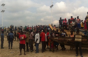 Some navy personnel and fishermen at the shore of the Tema Fishing Harbour