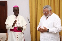 Most Rev Kwofie (left) praying for former President Rawlings