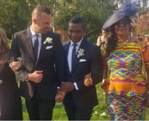 Stephen Kabutey holding hands with his gay partner and being accompanied by his mother.