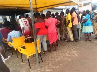 People waiting in line to register their sim cards