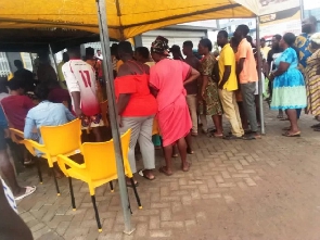 People waiting in line to register their sim cards