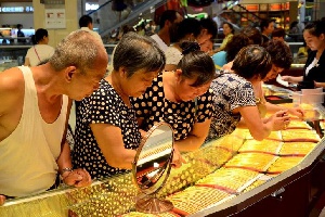 Customers Look At Gold Necklaces At A Jewelry Store In Xuchang, Henan Province. Reuters