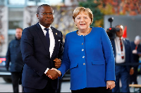 German Chancellor Angela Merkel welcomes Benin's Finance Minister Romuald Wadagni at the Chanceller