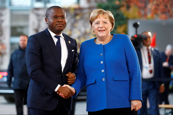 German Chancellor Angela Merkel welcomes Benin's Finance Minister Romuald Wadagni at the Chanceller