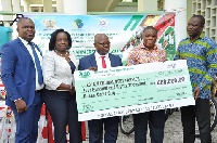 The MD of ADB, Dr. Kofi Mensah [M] presenting a dummy cheque to the Ministry of Food and Agriculture