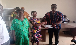 DCE Ceaser Ofosu Acheampong making presentation to one of the beneficiaries