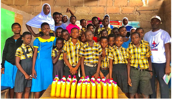 A beneficiary school in a pose with their products