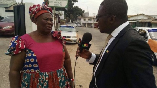 Hajia Fati speaking to a journalist in front of NPP headquarters