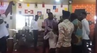 Ernest Opoku (kneeling) during the deliverance, surrounded by Eagle Prophet and his junior pastors